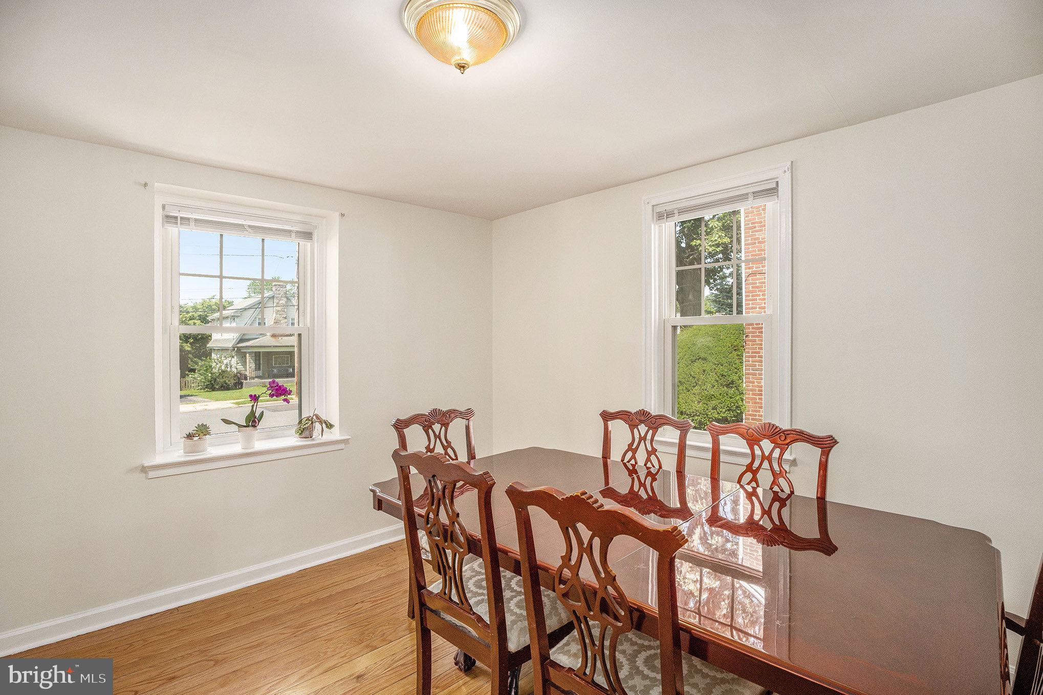 2209 East County Line Road Ardmore, PA 19003 - Photo 9 of 28 a view of a dining room with furniture and wooden floor