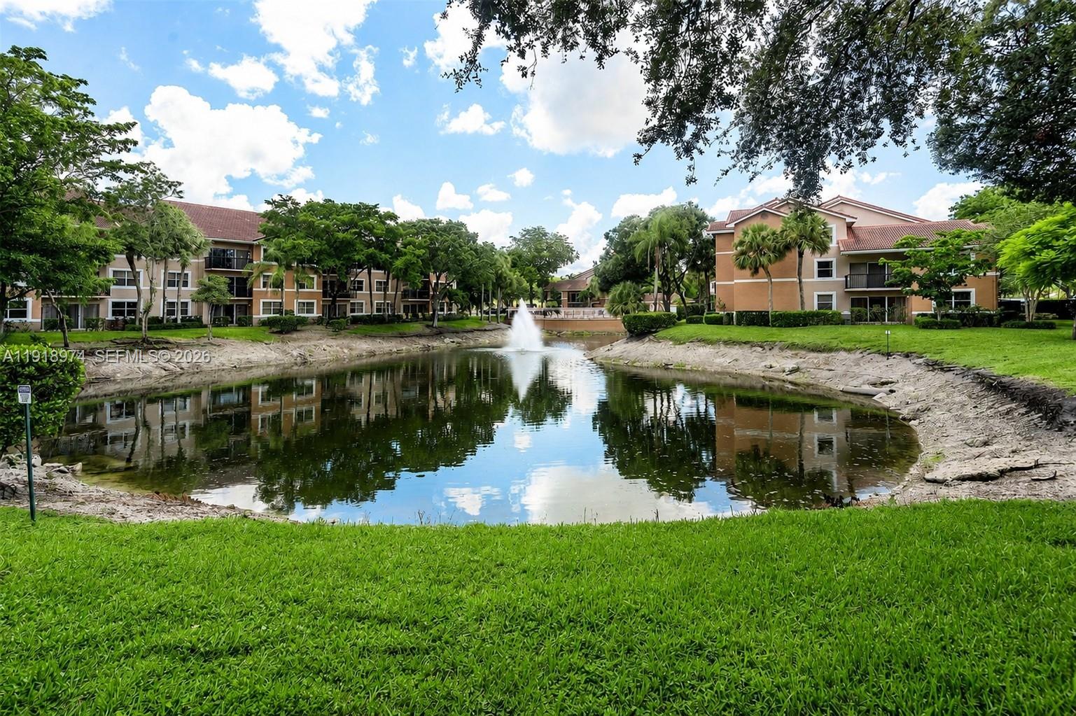 8801 Wiles Road, Unit 307 Coral Springs, FL 33067 - Photo 17 of 18 a view of a house with a yard and sitting area