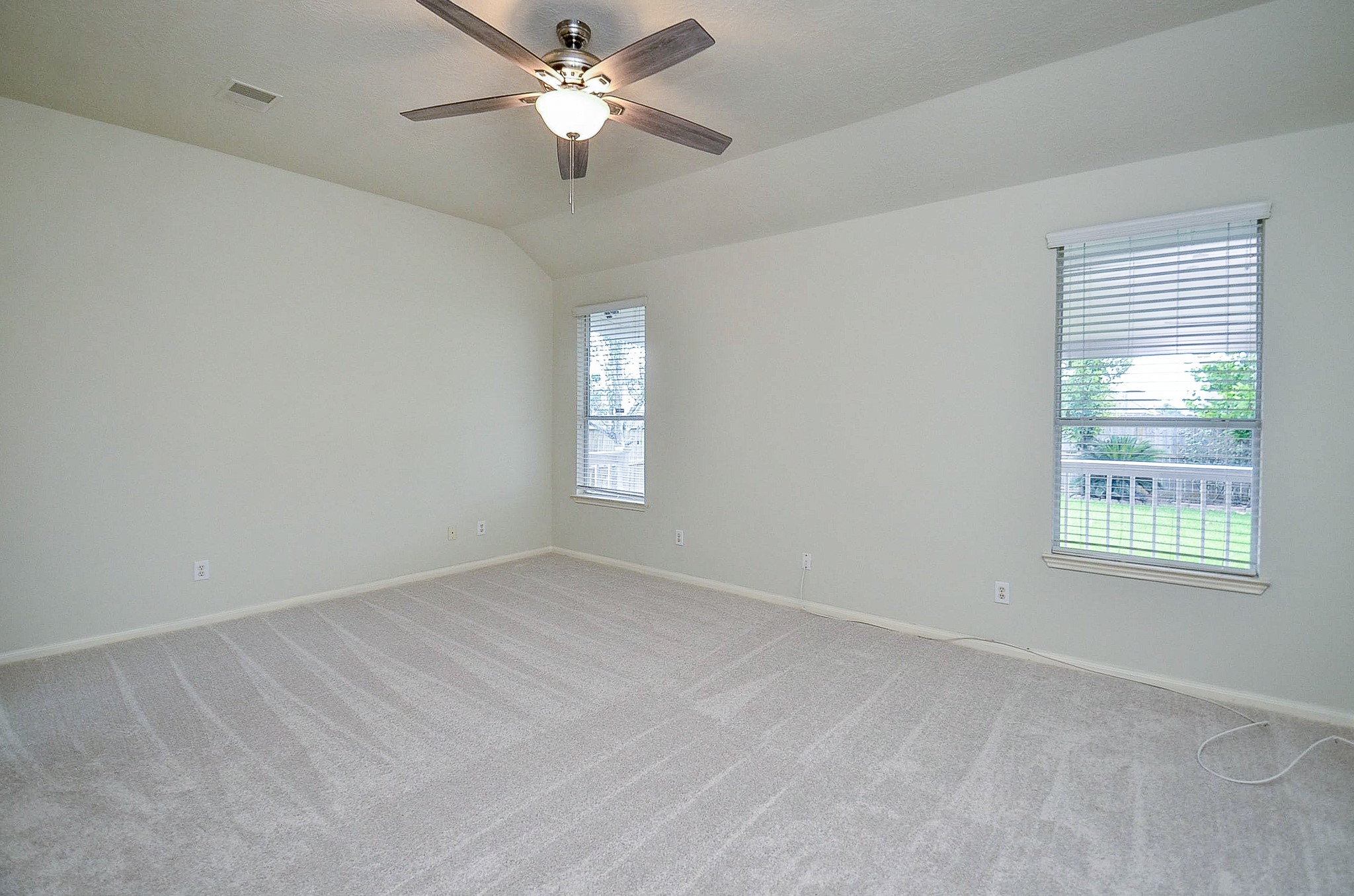 91 Rodeo Drive Manvel, TX 77578 - Photo 12 of 38 The primary bedroom is on the first floor and overlooks the backyard.