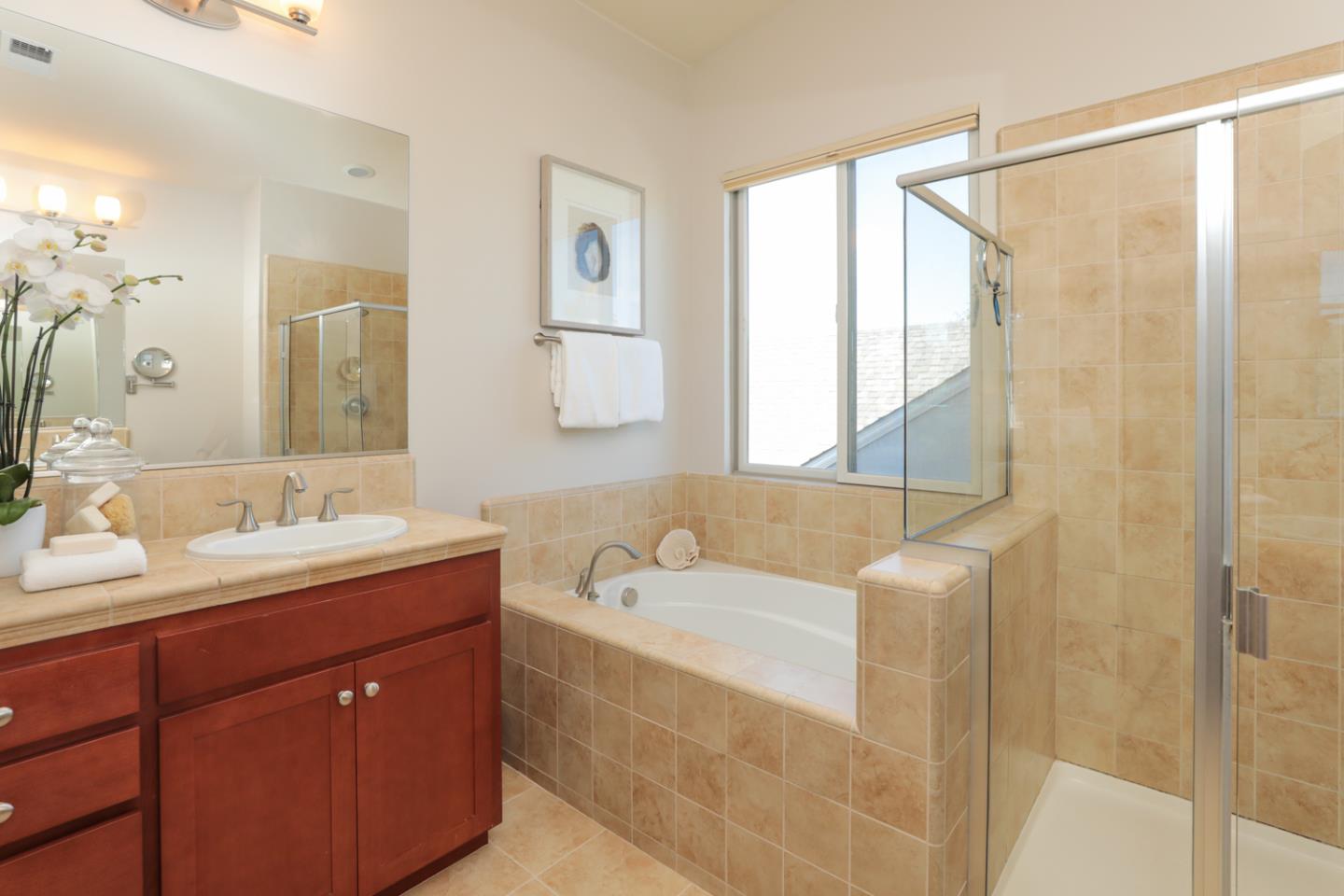 1143 Creek Way Mountain View, CA 94040 - Photo 16 of 24 a bathroom with a tub a sink and mirror