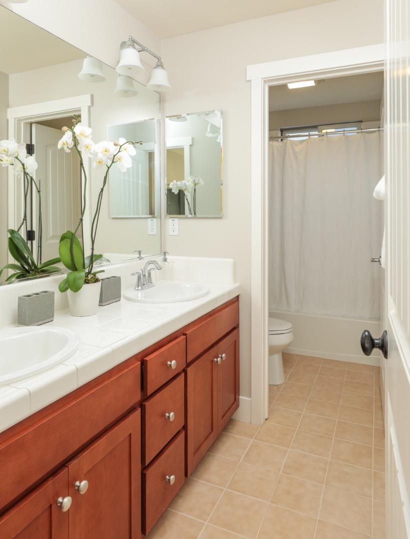 1143 Creek Way Mountain View, CA 94040 - Photo 17 of 24 a spacious bathroom with a double vanity sink toilet mirror and shower