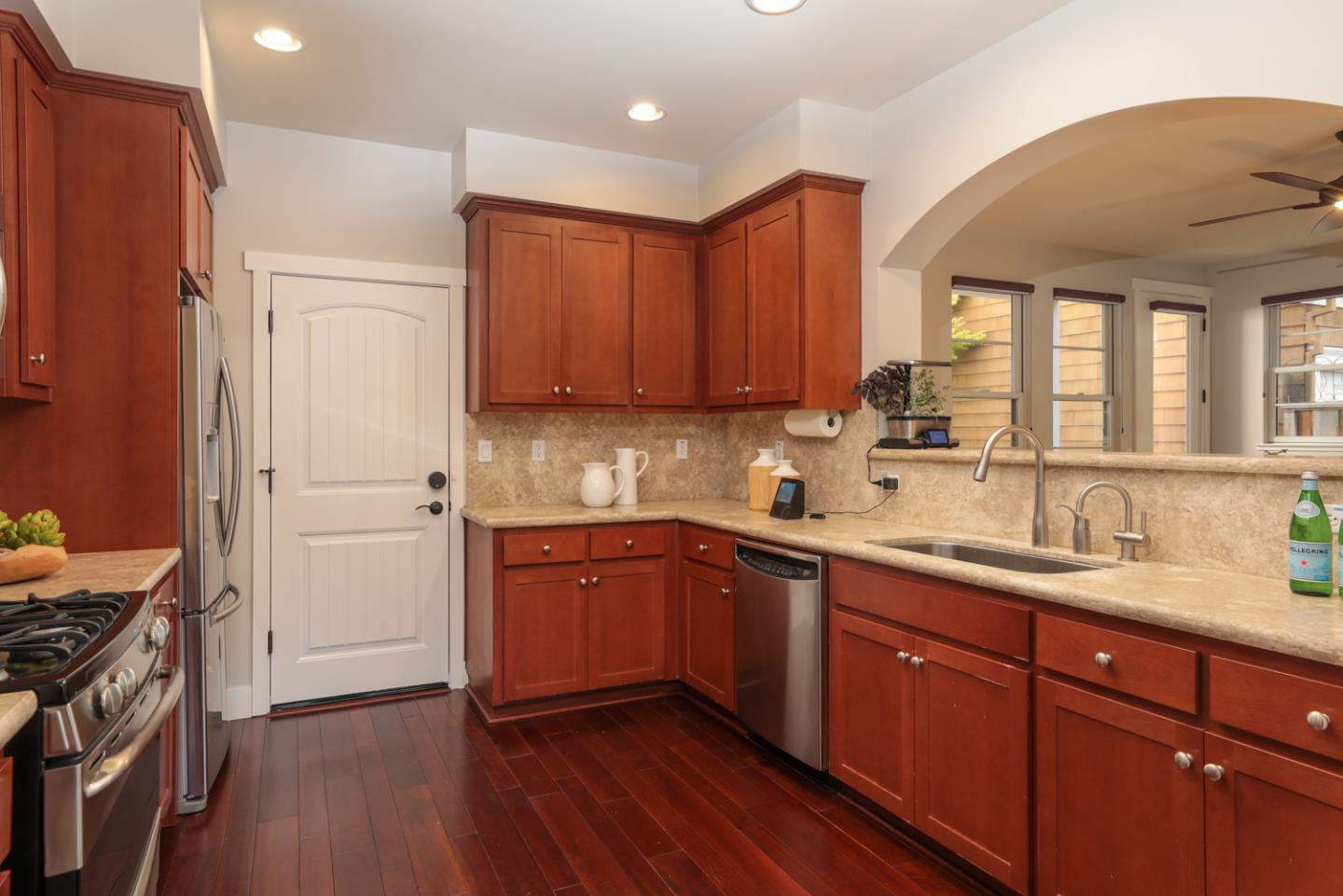 1143 Creek Way Mountain View, CA 94040 - Photo 4 of 24 a kitchen with a sink cabinets stainless steel appliances and a window