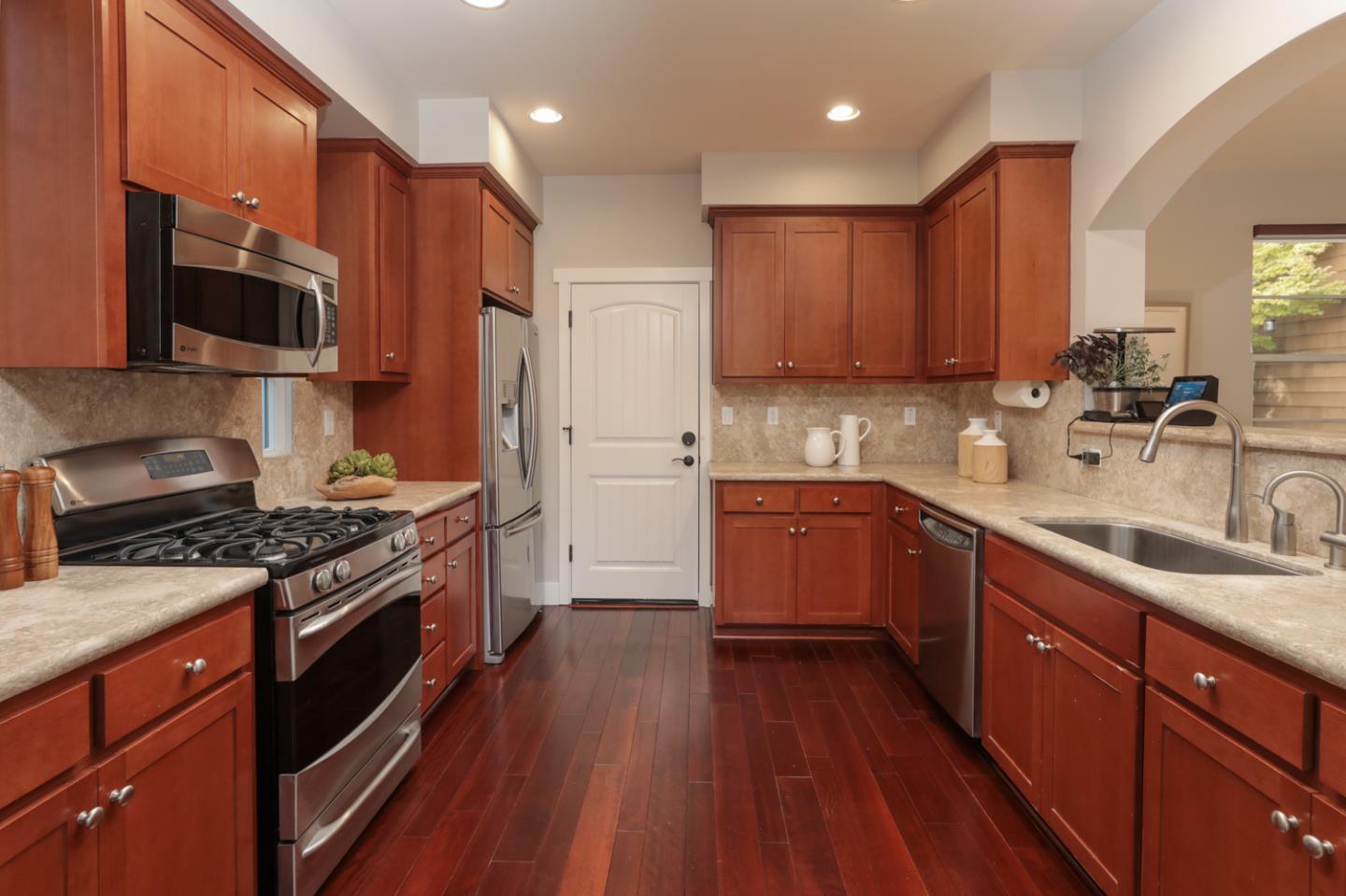 1143 Creek Way Mountain View, CA 94040 - Photo 5 of 24 a kitchen with stainless steel appliances granite countertop a stove a sink dishwasher and a microwave oven with wooden floor