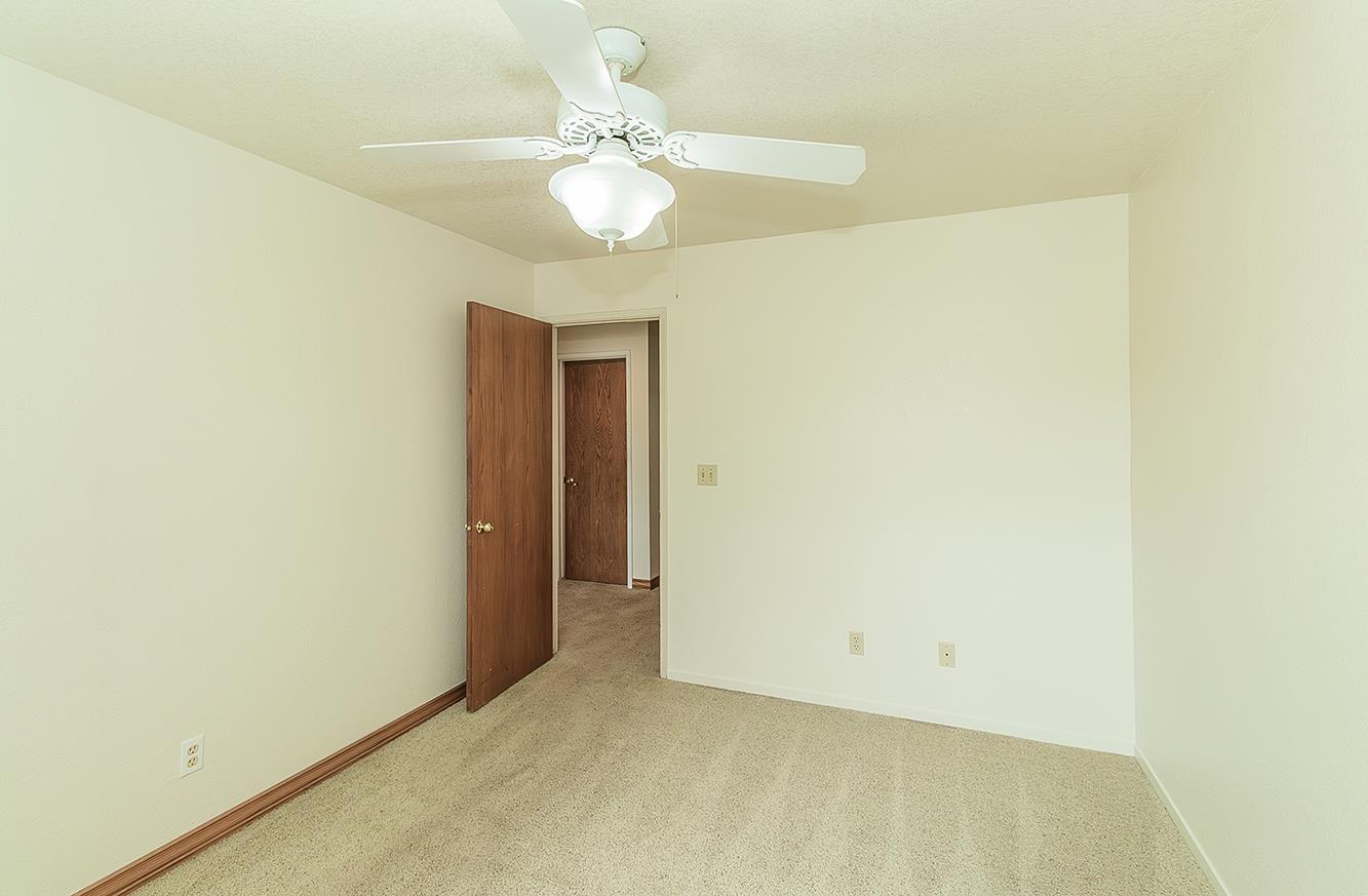 15501 Garlock Lane Prather, CA 93651 - Photo 21 of 47 an empty room with a chandelier fan
