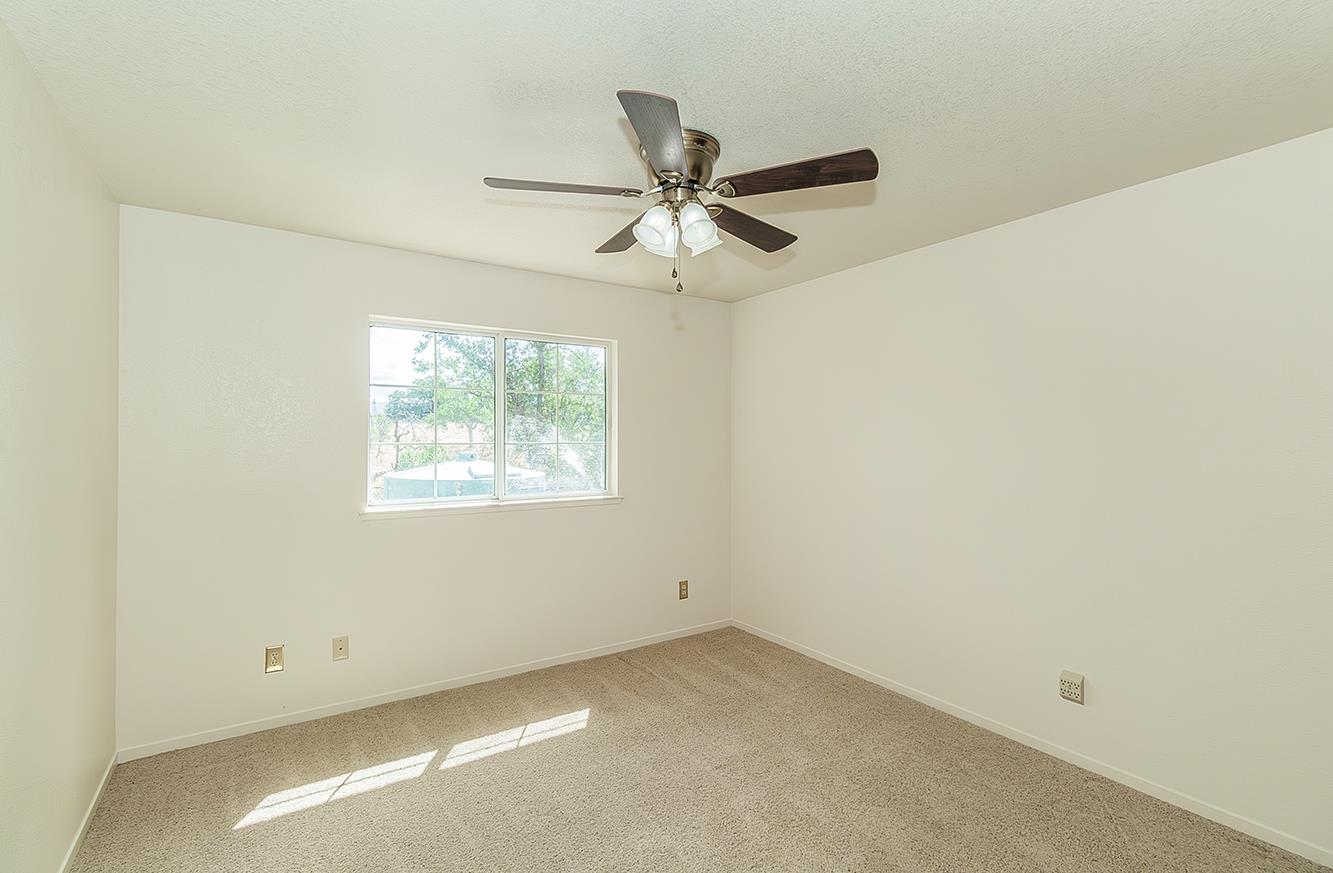 15501 Garlock Lane Prather, CA 93651 - Photo 24 of 47 an empty room with a window and a fan