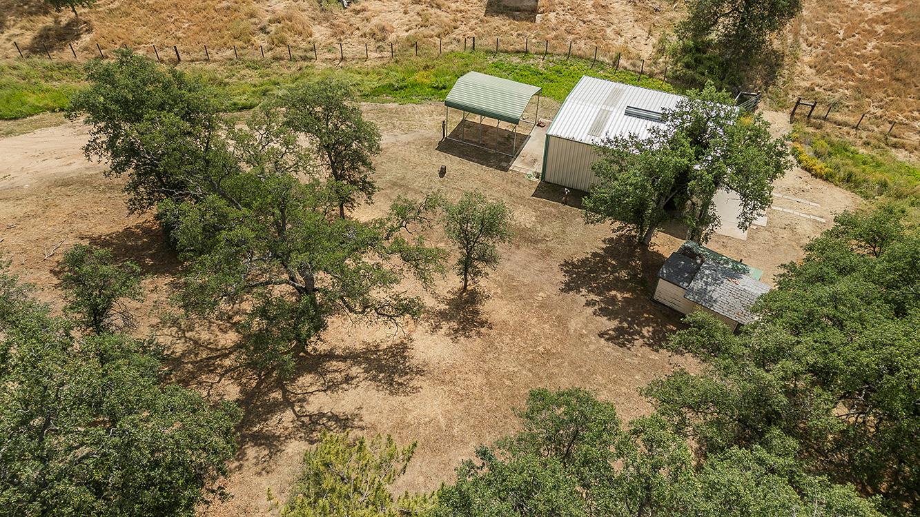 15501 Garlock Lane Prather, CA 93651 - Photo 37 of 47 a view of a backyard with plants and a bench