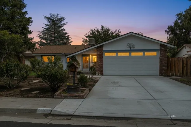 a front view of a house with yard