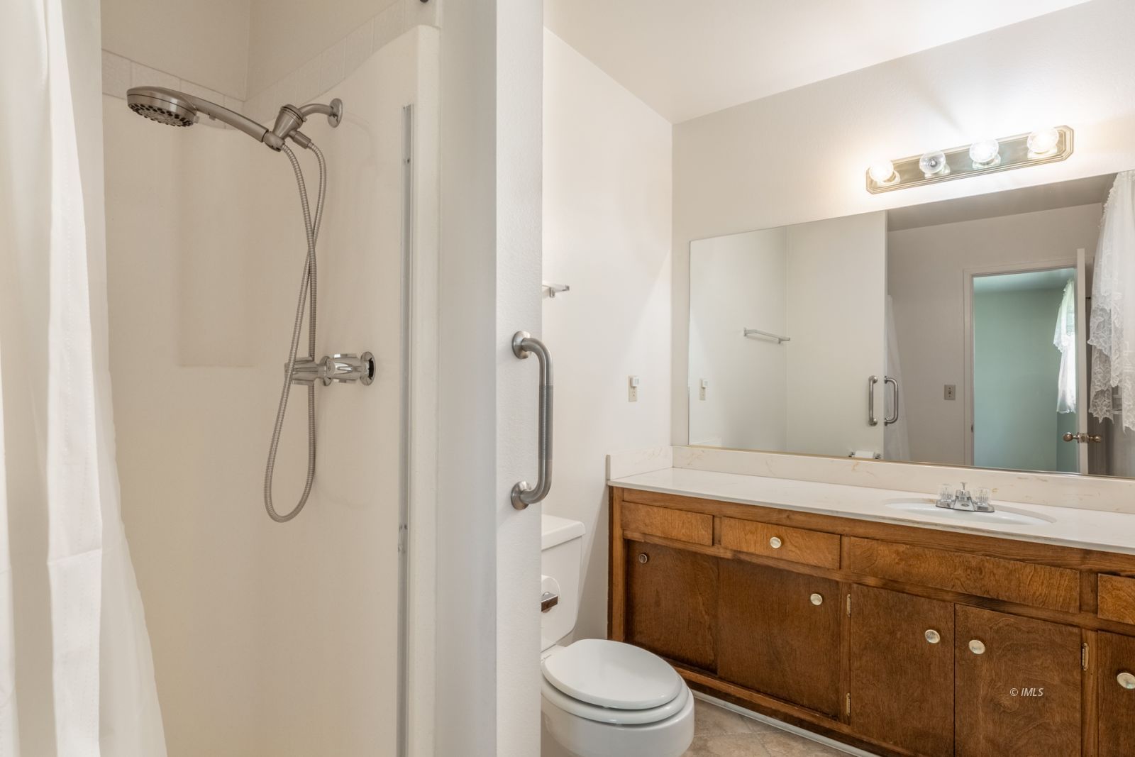 1424 Rocking W Drive Bishop, CA 93514 - Photo 15 of 27 a bathroom with a granite countertop sink toilet a mirror a vanity and shower