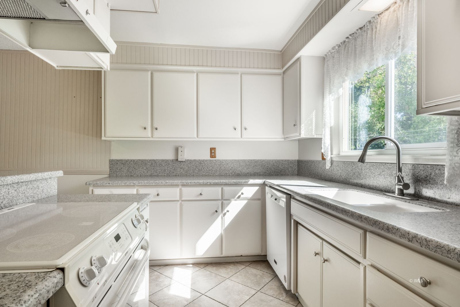 1424 Rocking W Drive Bishop, CA 93514 - Photo 3 of 27 a kitchen with granite countertop a sink stove and cabinets