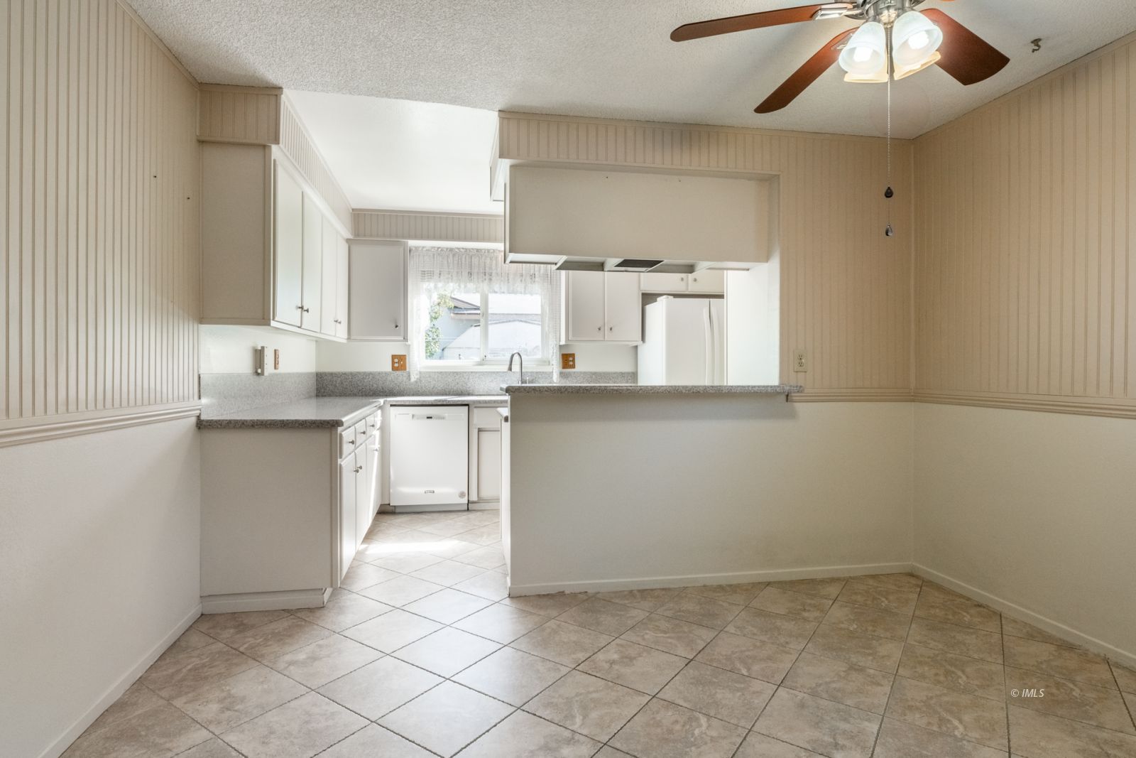 1424 Rocking W Drive Bishop, CA 93514 - Photo 5 of 27 a kitchen with a sink window and cabinets