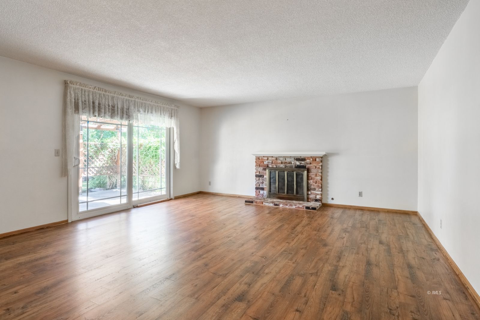 1424 Rocking W Drive Bishop, CA 93514 - Photo 9 of 27 a view of an empty room with wooden floor and a window