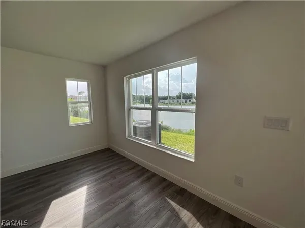 a bathroom with a granite countertop sink mirror and toilet