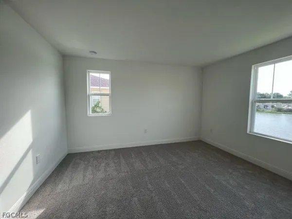 an empty room with a window and a bathroom