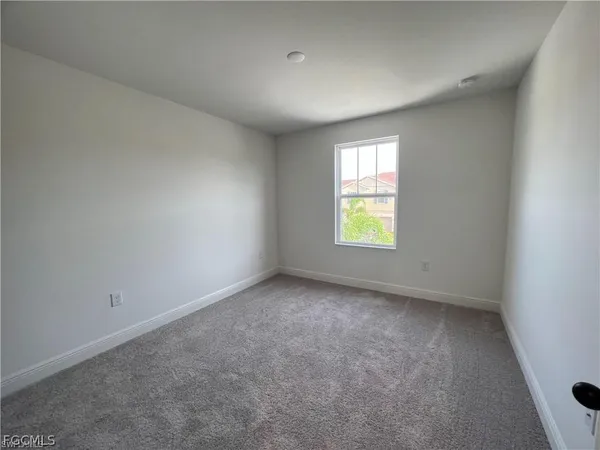 a view of walk in closet with clothes