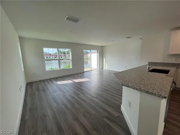 a view of a hallway with wooden floor and closet