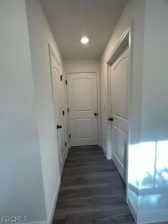 a view of a room with wooden floor and window
