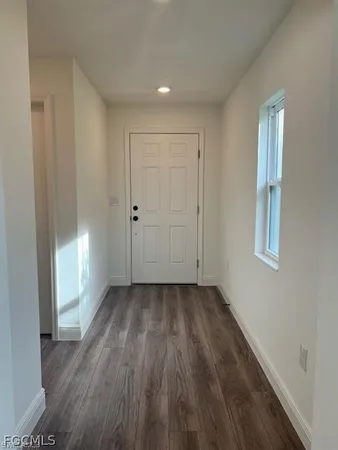 a view of kitchen with wooden floor and electronic appliances