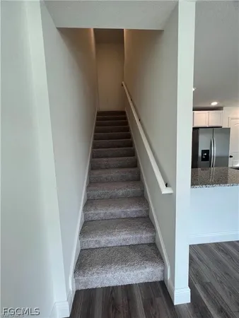 a view of empty room with wooden floor and windows
