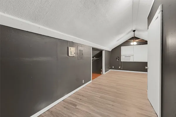 a view of a kitchen with wooden floor and a ceiling fan