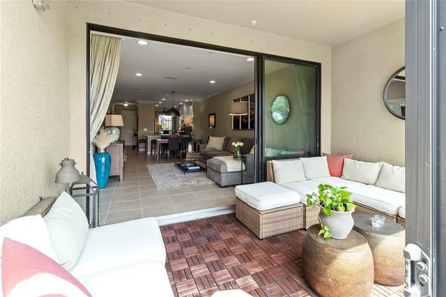 a view of a swimming pool with a table and chairs under an umbrella