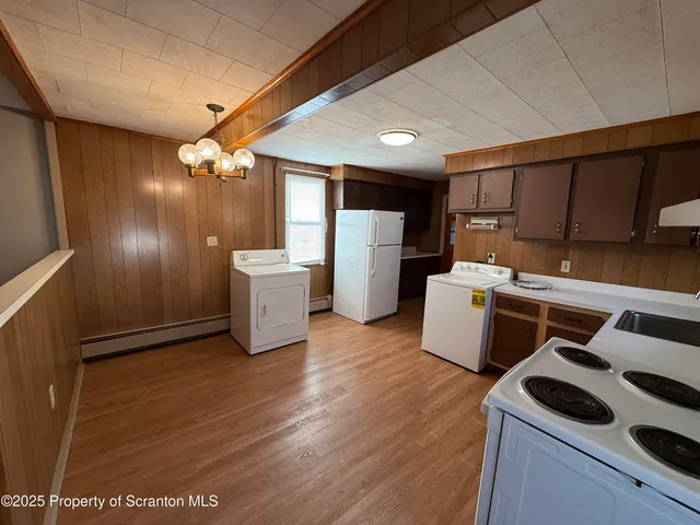 a kitchen with a sink a refrigerator and cabinets