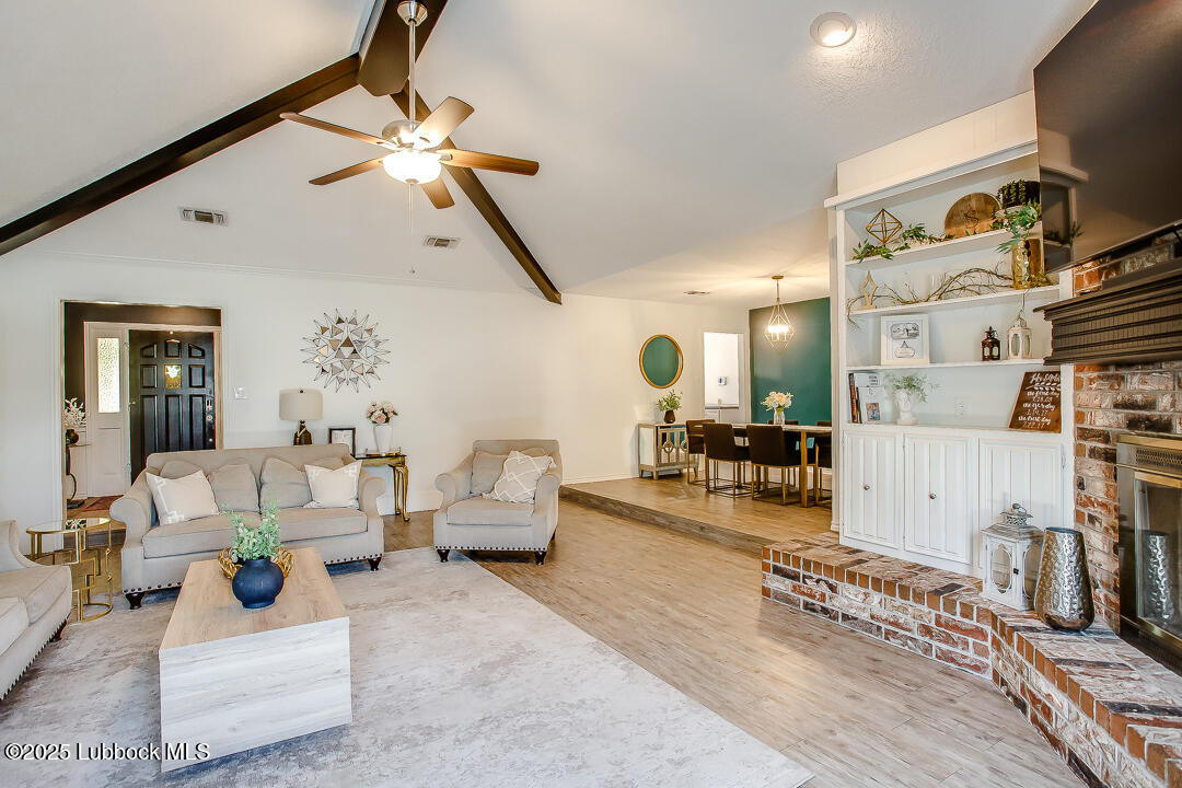 2912 76th Street Lubbock, TX 79423 - Photo 9 of 34 a living room with furniture and a flat screen tv
