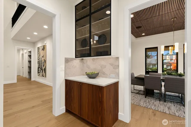 a living room with stainless steel appliances kitchen island granite countertop furniture a rug and a window