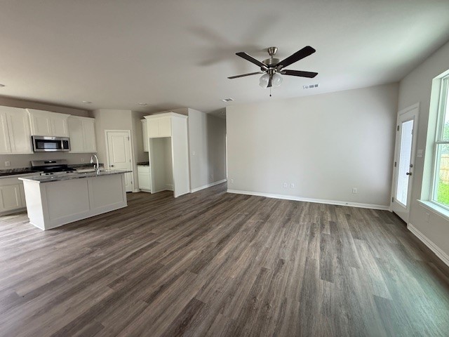 2602 Falcon Ridge Drive Bryan, TX 77803 - Photo 4 of 15 a view of a kitchen with a sink a ceiling fan and wooden floor