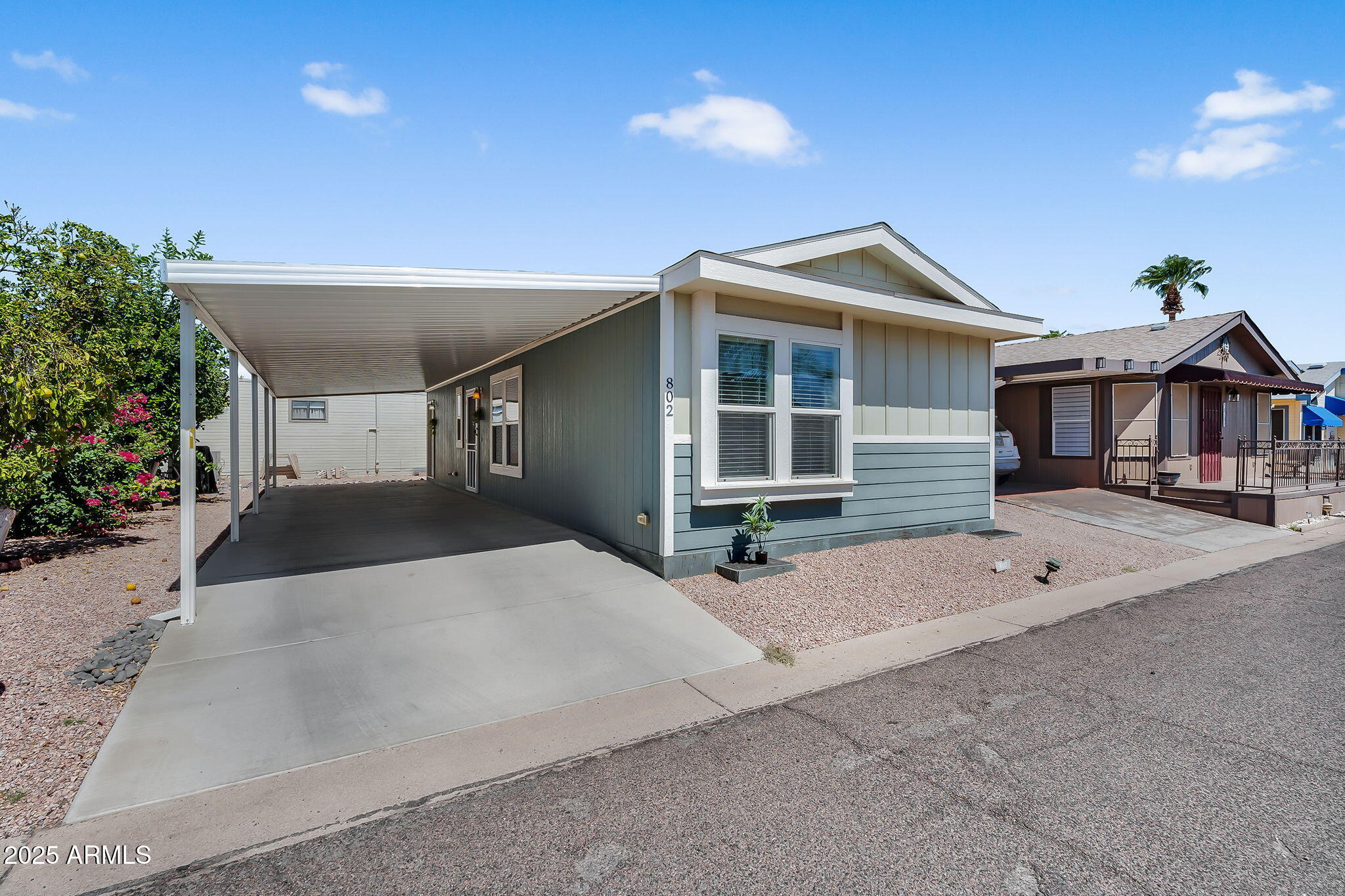 8865 East Baseline Road, Unit 802 Mesa, AZ 85209 - Photo 21 of 44 a front view of a house with a yard and garage