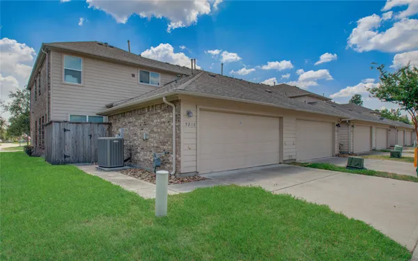 a view of a backyard with wooden fence