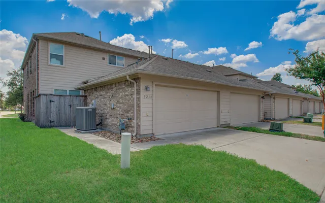 a view of a backyard with wooden fence
