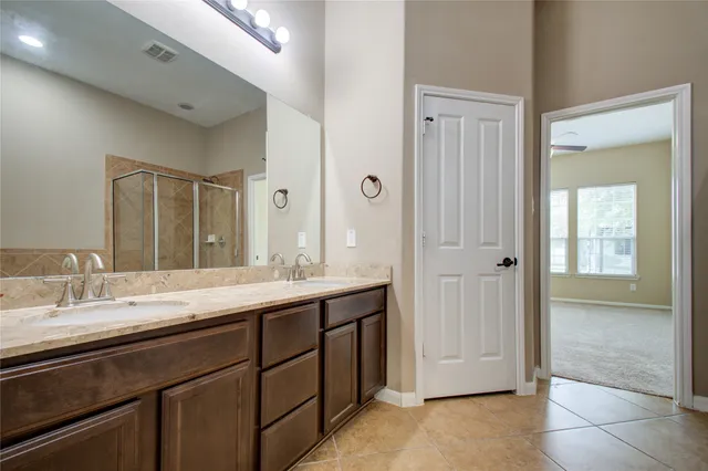 a bathroom with a granite countertop sink mirror and double