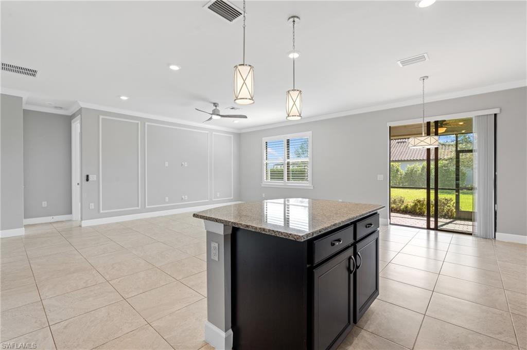 19953 Beverly Park Road Estero, FL 33928 - Photo 11 of 50 Kitchen with visible vents, crown molding, and a decorative wall