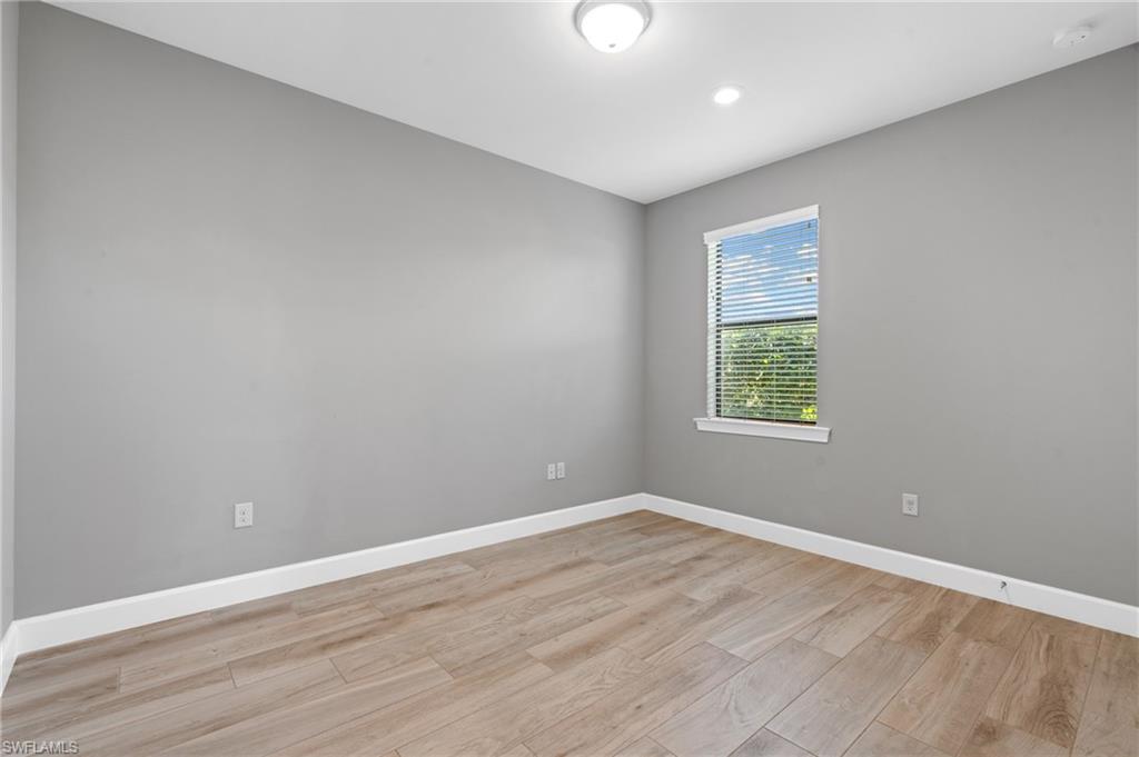 19953 Beverly Park Road Estero, FL 33928 - Photo 12 of 50 Spare room with light wood finished floors and baseboards