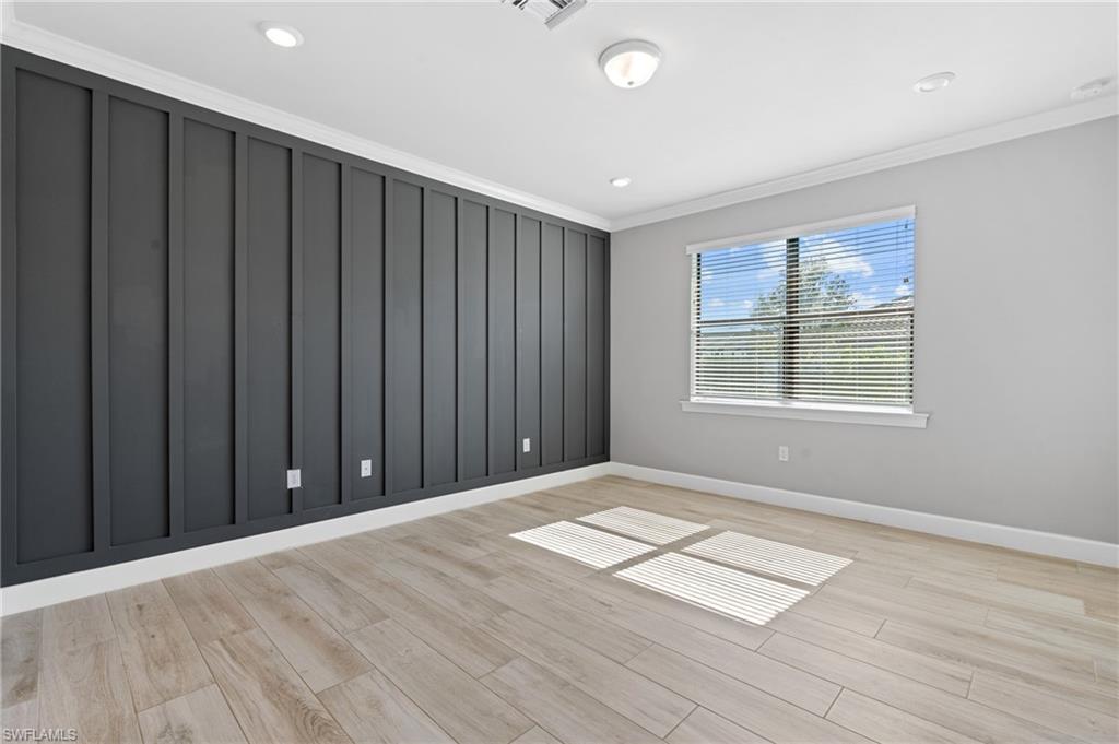 19953 Beverly Park Road Estero, FL 33928 - Photo 17 of 50 Unfurnished room featuring recessed lighting, light wood-type flooring, crown molding, and baseboards