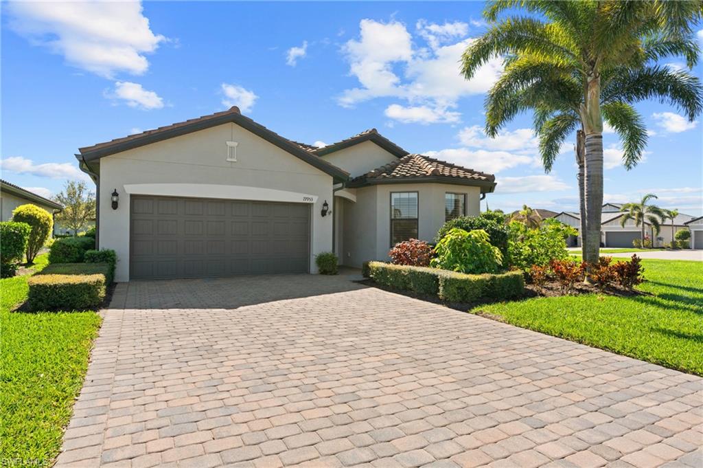 19953 Beverly Park Road Estero, FL 33928 - Photo 31 of 50 Mediterranean / spanish-style home featuring a tiled roof, stucco siding, an attached garage, and decorative driveway