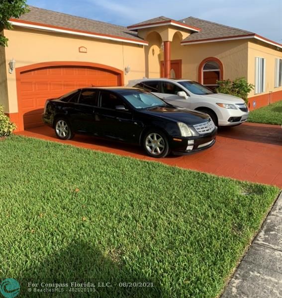 a view of a backyard with a car parked