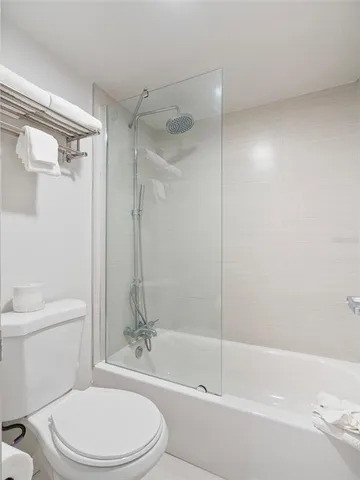 a bathroom with a toilet and a bathtub