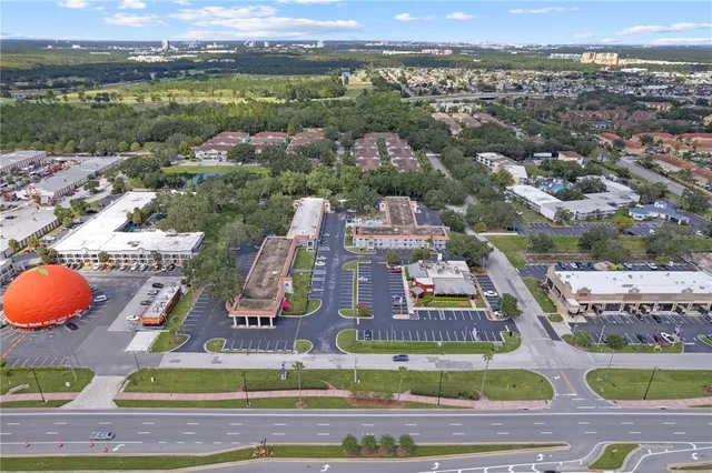 an aerial view of residential houses with outdoor space and city view