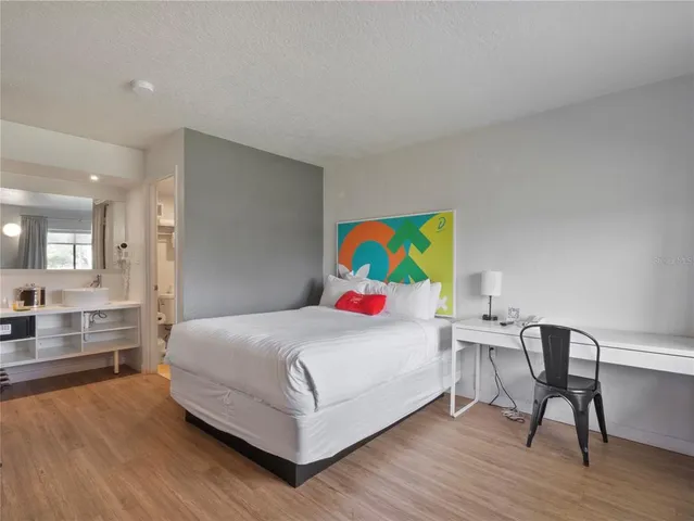 a bedroom with a bed and a desk