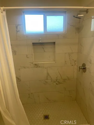 a bathroom with a window sink and shower
