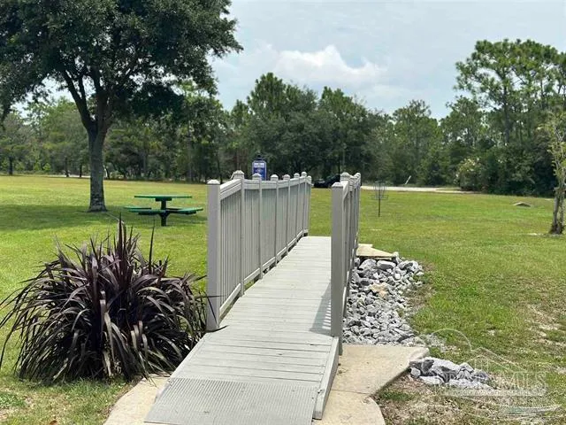 a view of a garden with wooden fence