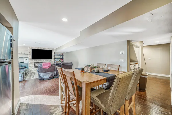 a view of a dining room with furniture wooden floor and a rug