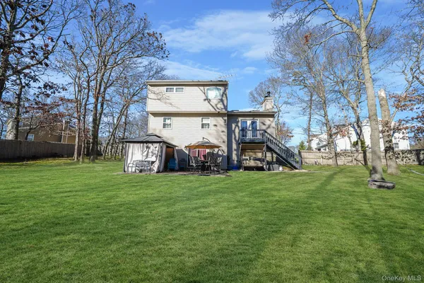 a view of a house with a big yard and a large tree