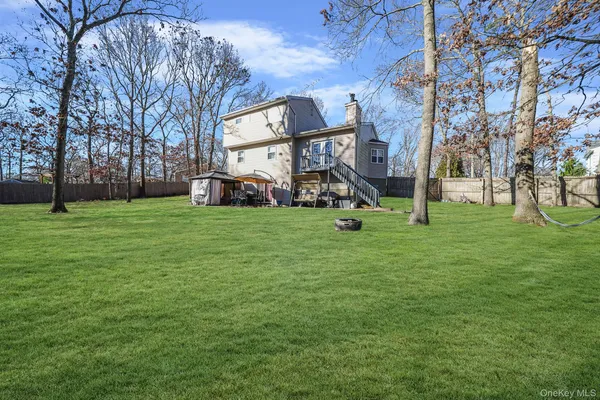 a view of a park with swings and a tree