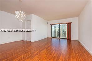 4242 Northwest 2nd Street, Unit 1012 Miami, FL 33126 - Photo 6 of 17 a view of an empty room with wooden floor and a window