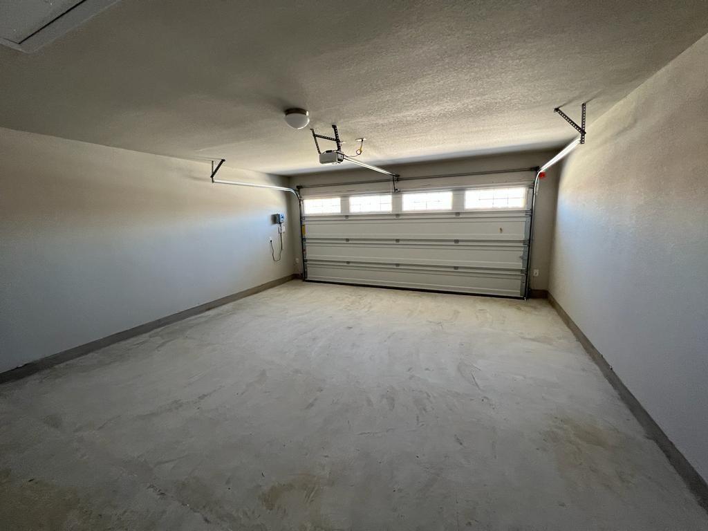 105 Spiny Lizard Lane San Marcos, TX 78666 - Photo 16 of 34 Garage featuring baseboards