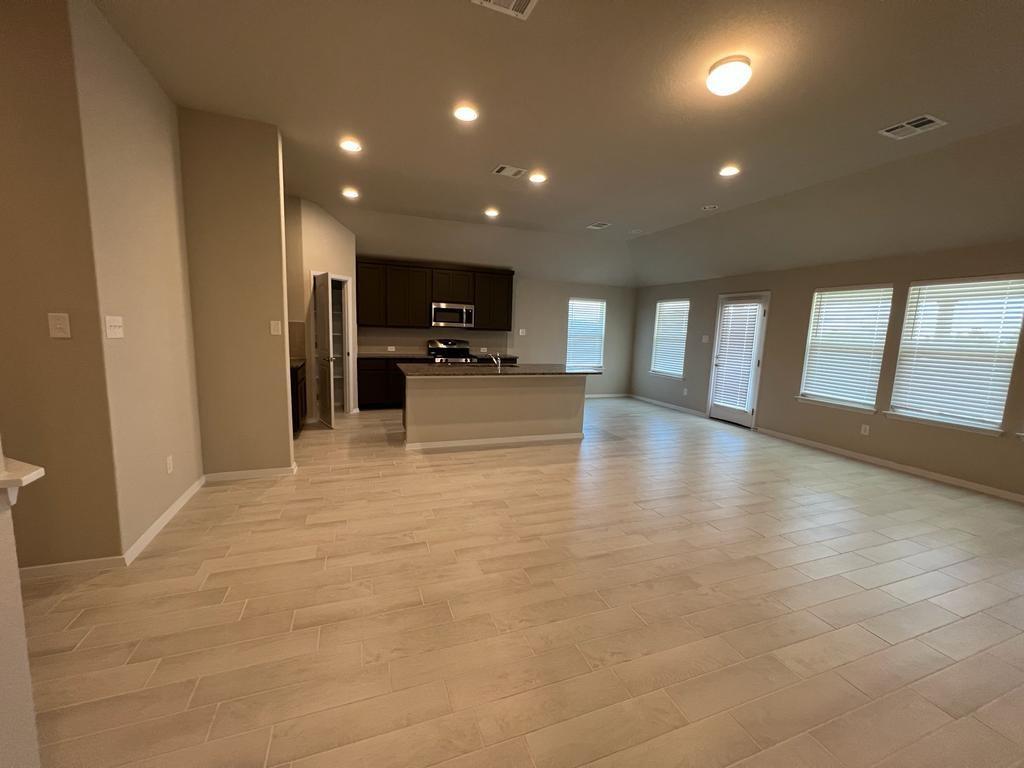 105 Spiny Lizard Lane San Marcos, TX 78666 - Photo 17 of 34 Unfurnished living room featuring recessed lighting and vaulted ceiling