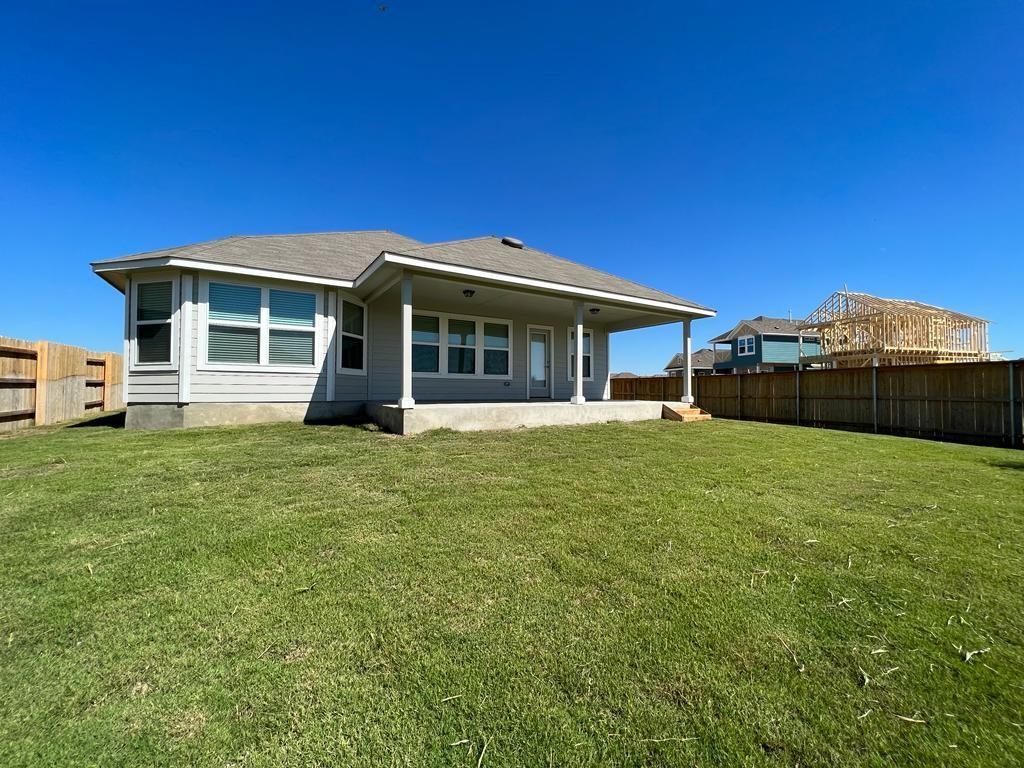 105 Spiny Lizard Lane San Marcos, TX 78666 - Photo 24 of 34 Back of property with a fenced backyard, a patio, and roof with shingles