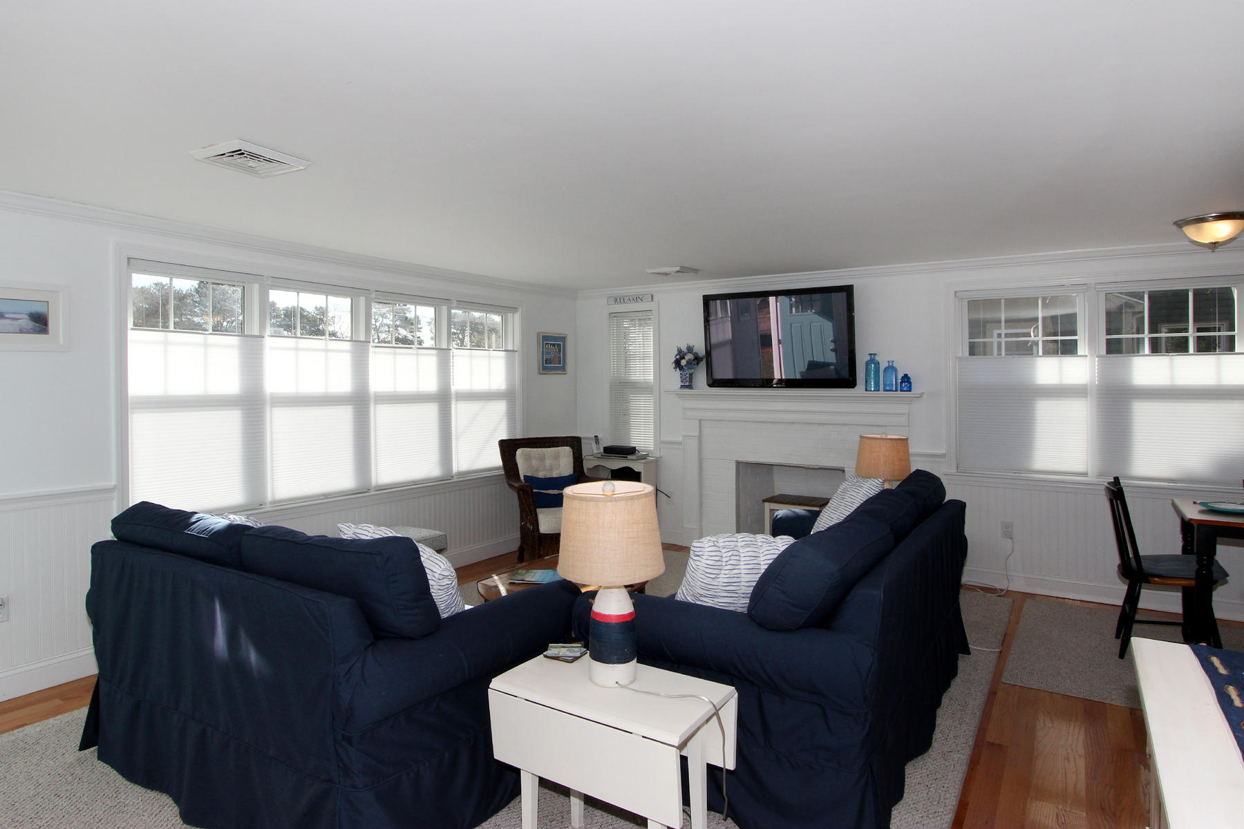 17 Bearse Road Mashpee, MA 02649 - Photo 9 of 24 a living room with furniture a fireplace and a flat screen tv